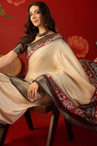 Cream silk cotton printed saree with unstitched blouse piece.