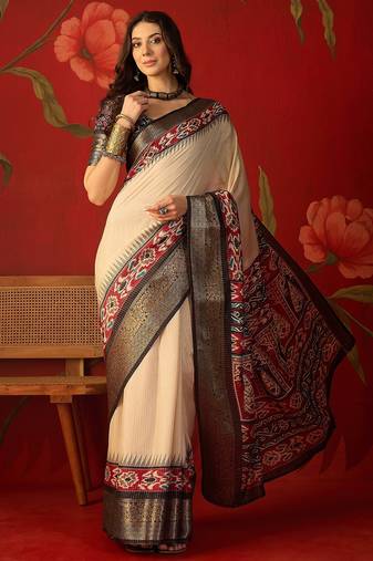 Cream silk cotton printed saree with unstitched blouse piece.
