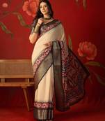 Cream silk cotton printed saree with unstitched blouse piece.