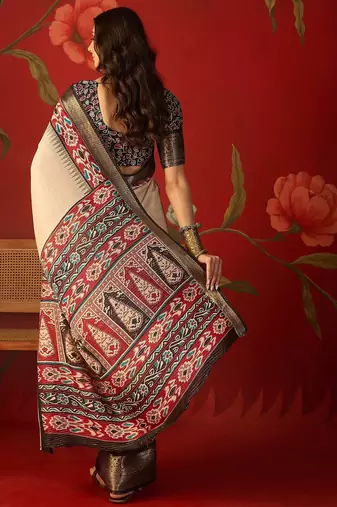 Cream silk cotton printed saree with unstitched blouse piece.
