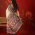 Cream silk cotton printed saree with unstitched blouse piece.
