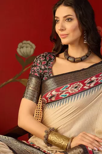 Cream silk cotton printed saree with unstitched blouse piece.