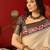 Cream silk cotton printed saree with unstitched blouse piece.