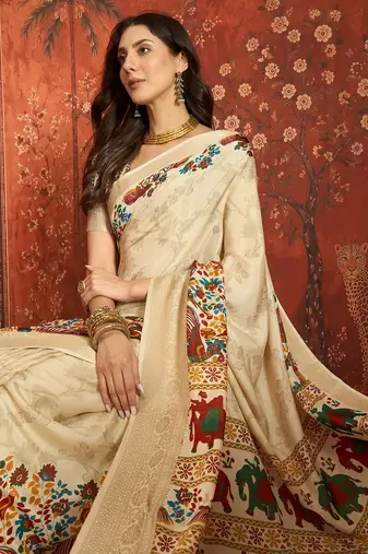 Cream silk cotton printed saree with unstitched blouse piece.