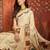 Cream silk cotton printed saree with unstitched blouse piece.