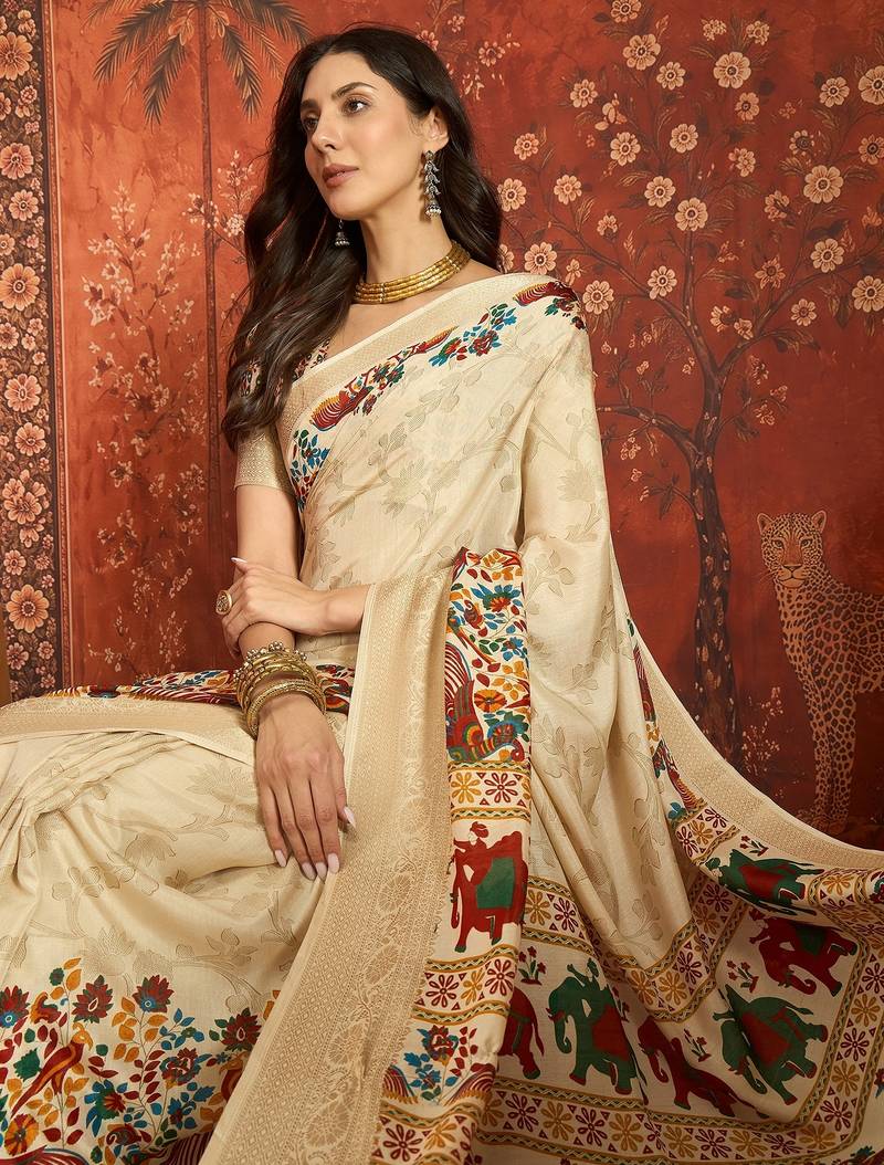 Cream silk cotton printed saree with unstitched blouse piece.