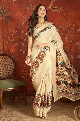 Cream silk cotton printed saree with unstitched blouse piece.