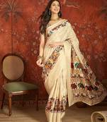 Cream silk cotton printed saree with unstitched blouse piece.