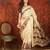 Cream silk cotton printed saree with unstitched blouse piece.