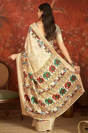 Cream silk cotton printed saree with unstitched blouse piece.