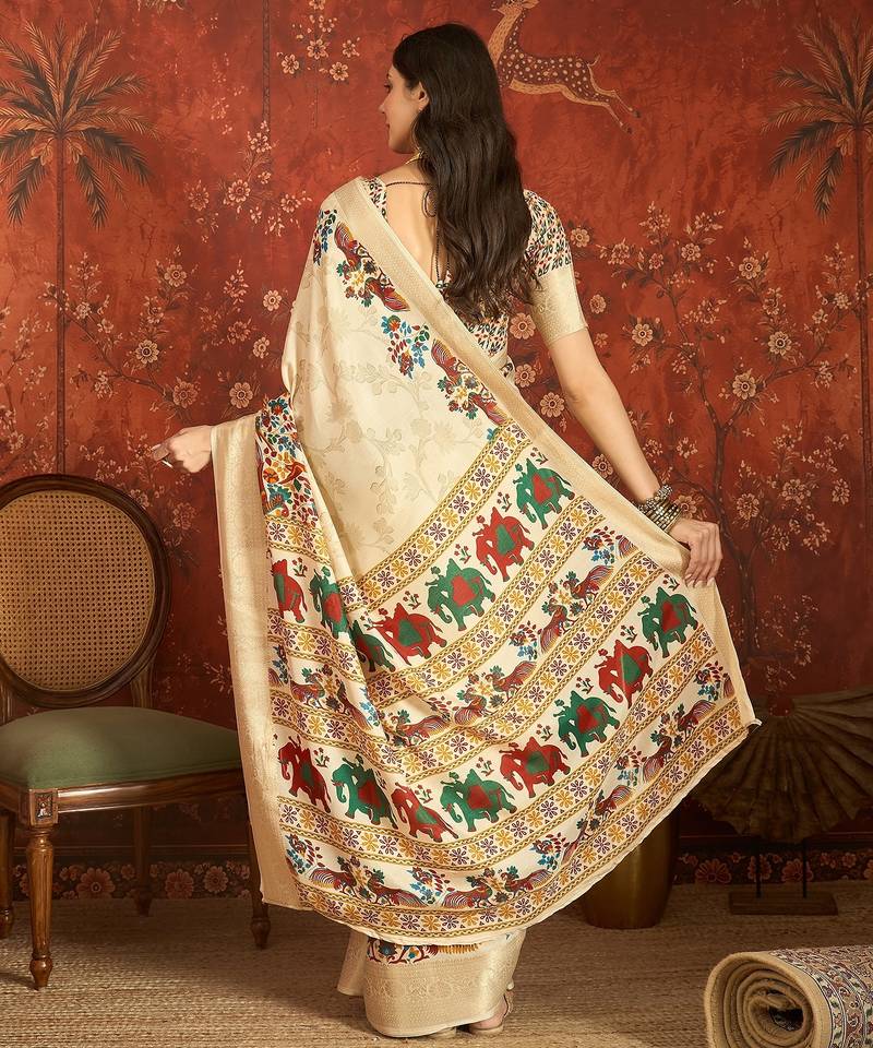 Cream silk cotton printed saree with unstitched blouse piece.