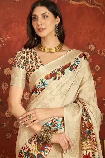 Cream silk cotton printed saree with unstitched blouse piece.