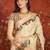 Cream silk cotton printed saree with unstitched blouse piece.