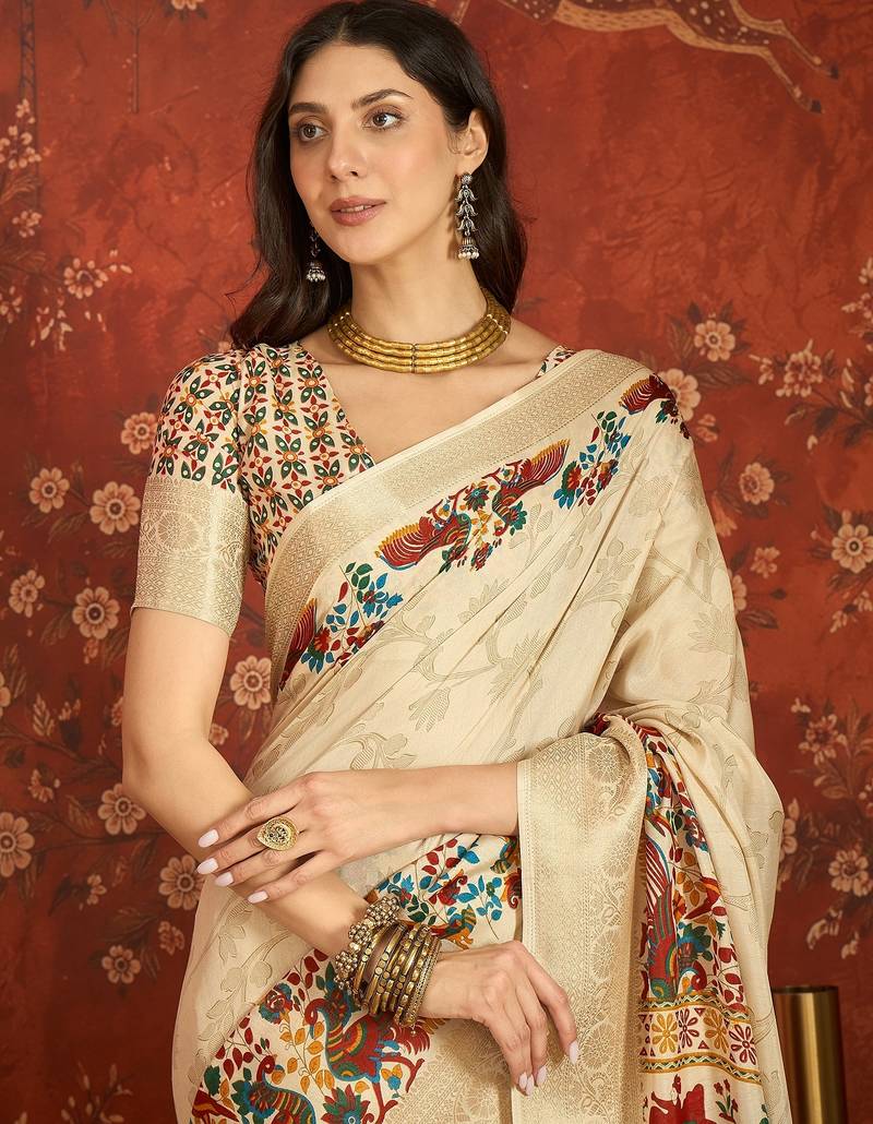 Cream silk cotton printed saree with unstitched blouse piece.