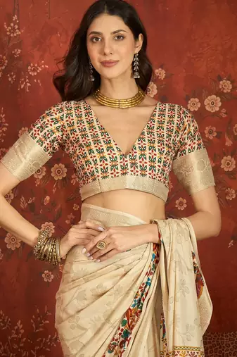 Cream silk cotton printed saree with unstitched blouse piece.