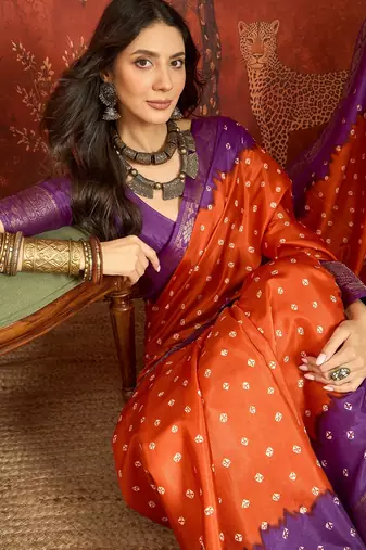 Orange silk cotton printed saree with unstitched blouse piece.