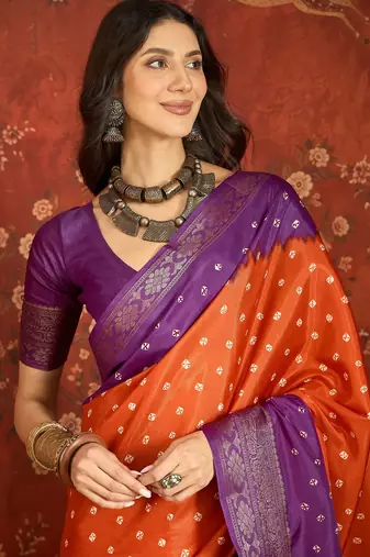 Orange silk cotton printed saree with unstitched blouse piece.