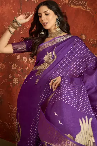 Purple silk cotton printed saree with unstitched blouse piece.