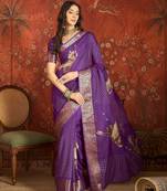Purple silk cotton printed saree with unstitched blouse piece.