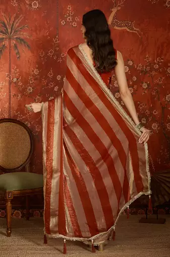 Orange & gold tissue satin sequins saree with unstitched blouse piece.