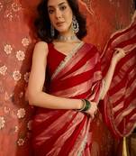 Rani & gold tissue satin sequins saree with unstitched blouse piece.