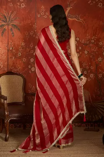 Rani & gold tissue satin sequins saree with unstitched blouse piece.