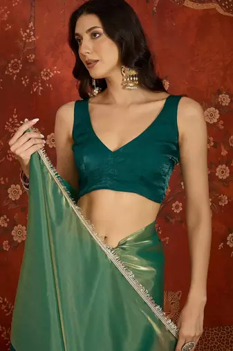 Rama & gold tissue satin sequins saree with unstitched blouse piece.