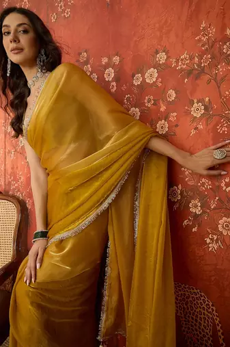 Yellow & gold tissue satin sequins saree with unstitched blouse piece.