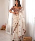 Cream tissue satin embroidered saree with unstitched blouse piece.