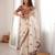 Cream tissue satin embroidered saree with unstitched blouse piece.