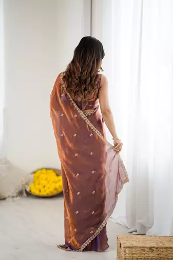 Brown tissue satin embroidered saree with unstitched blouse piece.