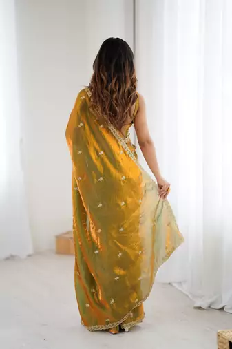 Gold tissue satin embroidered saree with unstitched blouse piece.