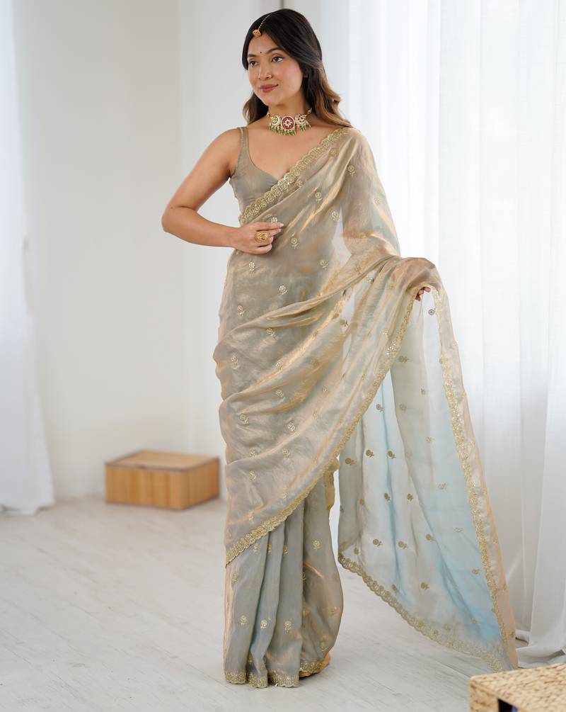 Grey tissue satin embroidered saree with unstitched blouse piece.