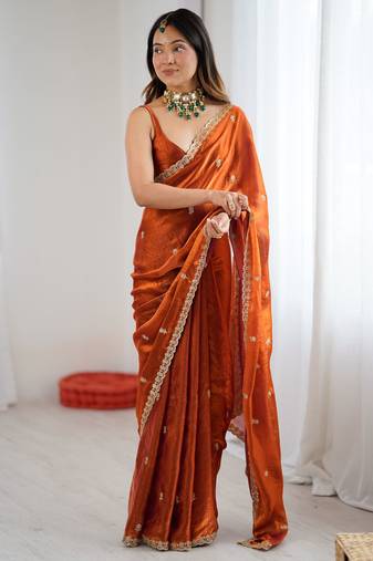 Orange tissue satin embroidered saree with unstitched blouse piece.