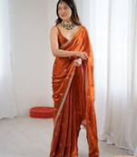 Orange tissue satin embroidered saree with unstitched blouse piece.