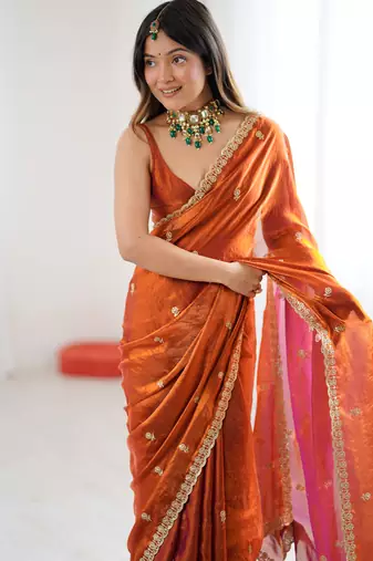 Orange tissue satin embroidered saree with unstitched blouse piece.