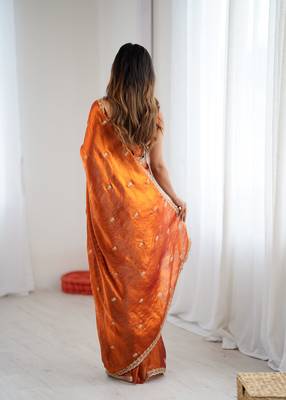 Orange tissue satin embroidered saree with unstitched blouse piece. 5