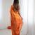 Orange tissue satin embroidered saree with unstitched blouse piece.