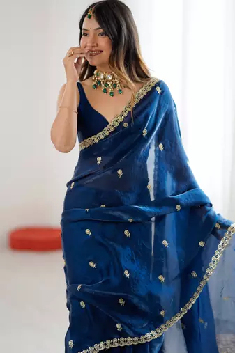 Teal tissue satin embroidered saree with unstitched blouse piece.