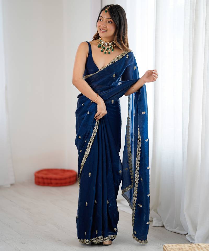 Teal tissue satin embroidered saree with unstitched blouse piece.