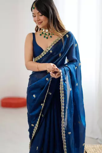 Teal tissue satin embroidered saree with unstitched blouse piece.