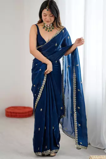 Teal tissue satin embroidered saree with unstitched blouse piece.