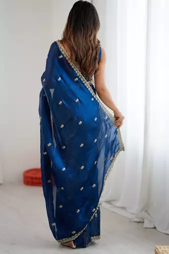 Teal tissue satin embroidered saree with unstitched blouse piece.