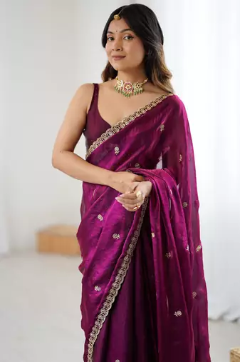 Wine tissue satin embroidered saree with unstitched blouse piece.