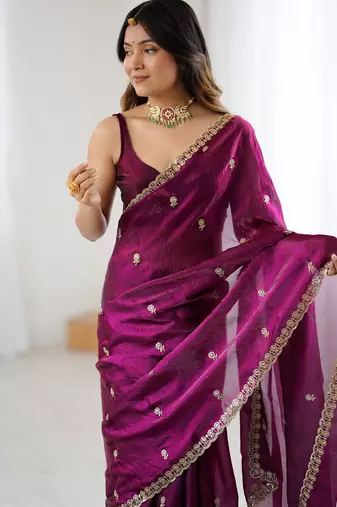 Wine tissue satin embroidered saree with unstitched blouse piece.