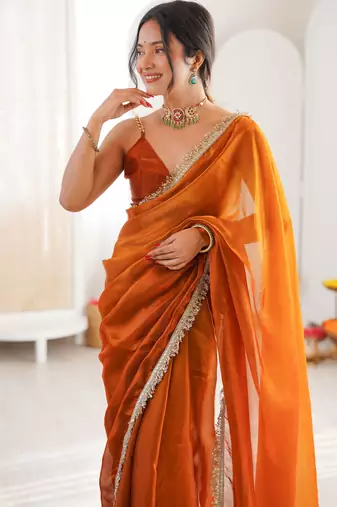 Mustard tissue satin sequins saree with unstitched blouse piece.