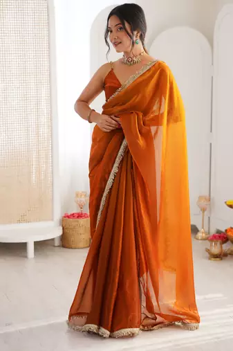 Mustard tissue satin sequins saree with unstitched blouse piece.