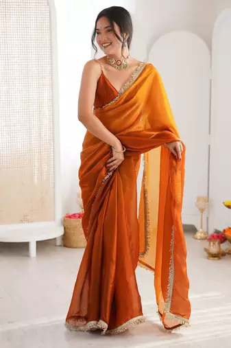 Mustard tissue satin sequins saree with unstitched blouse piece.