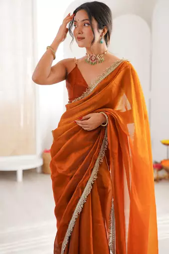 Mustard tissue satin sequins saree with unstitched blouse piece.