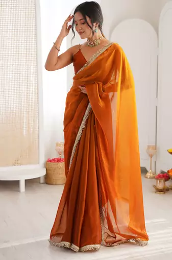 Mustard tissue satin sequins saree with unstitched blouse piece.